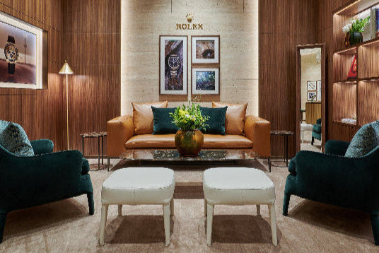 Luxury interior design with wooden walls, a brown sofa, and decorative items.
