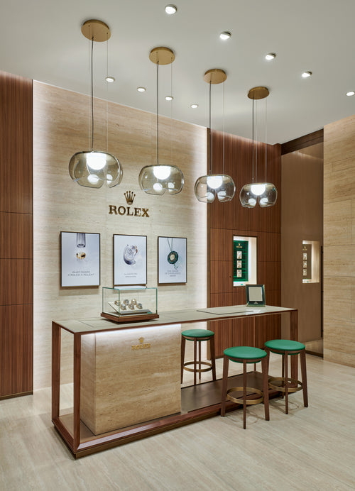 Rolex Boutique Detroit luxurious front room with watch bar and stools and drop lighting