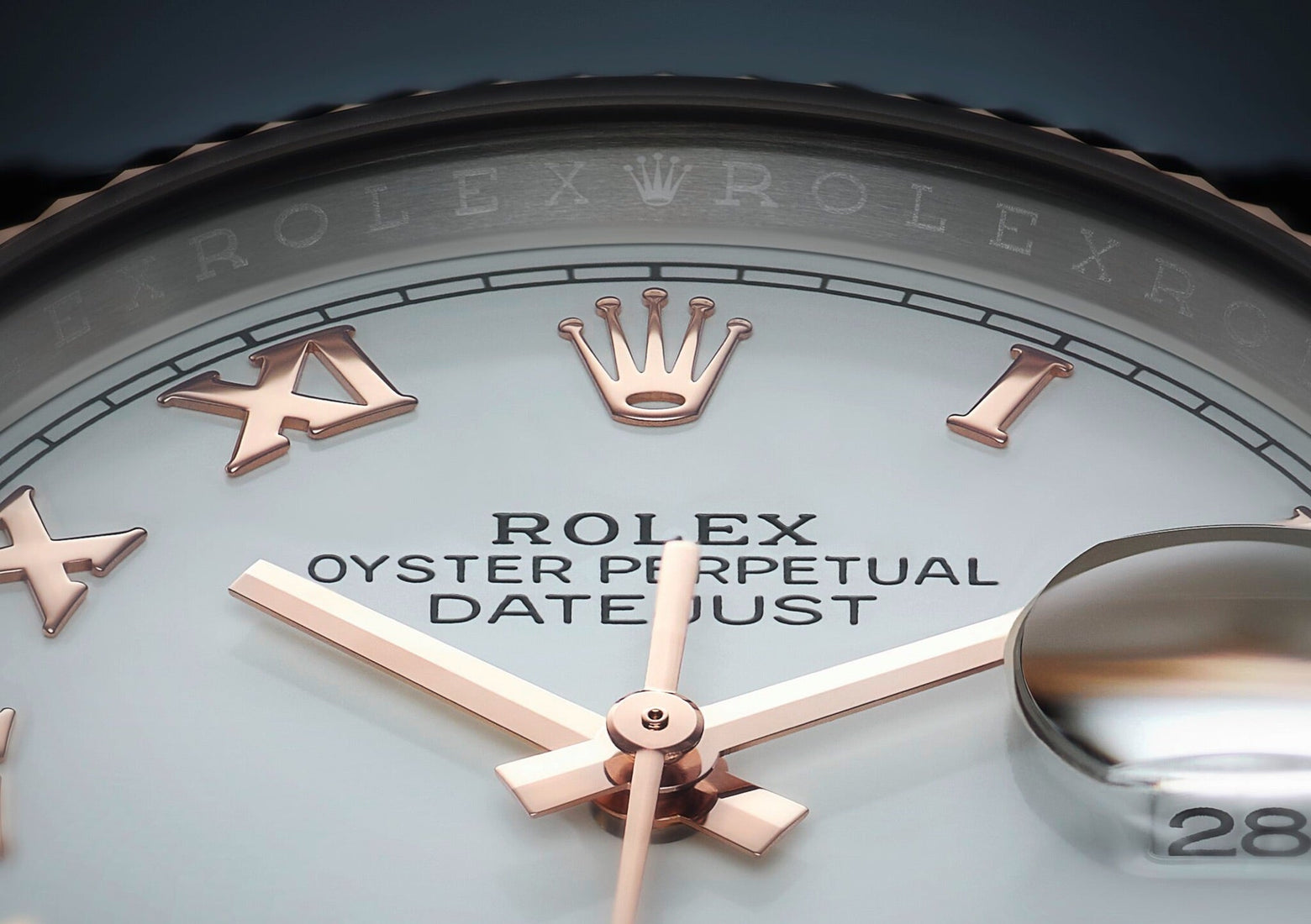 Extreme close-up of a Rolex Oyster Perpetual Datejust watch face, showing rose gold Roman numerals, hands, the Rolex crown logo, and a date window with magnifying lens.