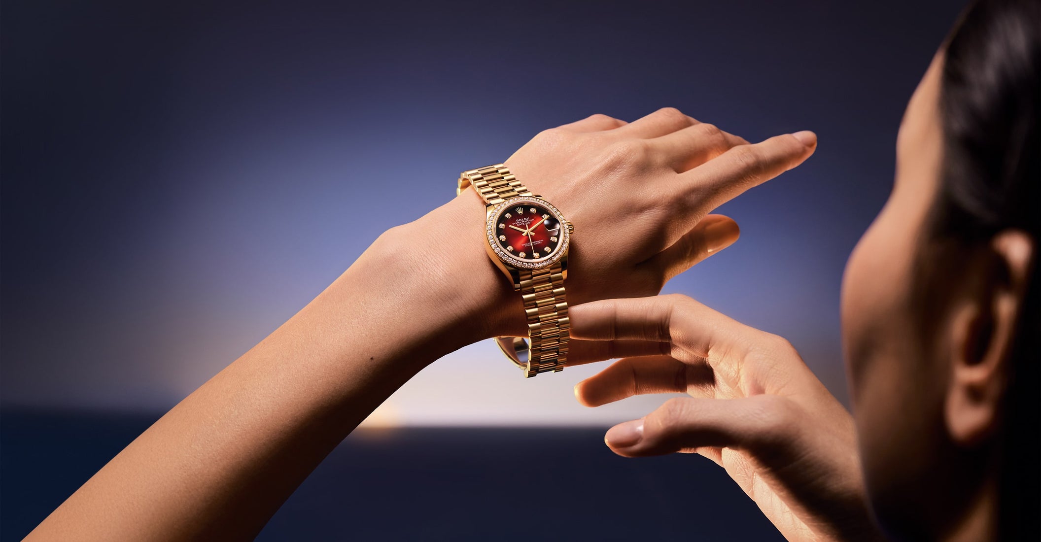 The image shows a Rolex Datejust watch in a refined ambiance, featuring a diamond bezel and metallic bracelet, with soft lighting that highlights its elegant design and luxurious details.