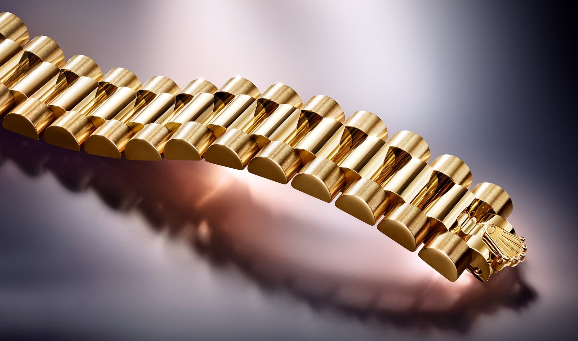 The image shows a close-up view of a Rolex Datejust bracelet, highlighting the intricate metal links and polished finish that emphasize its luxury and craftsmanship.