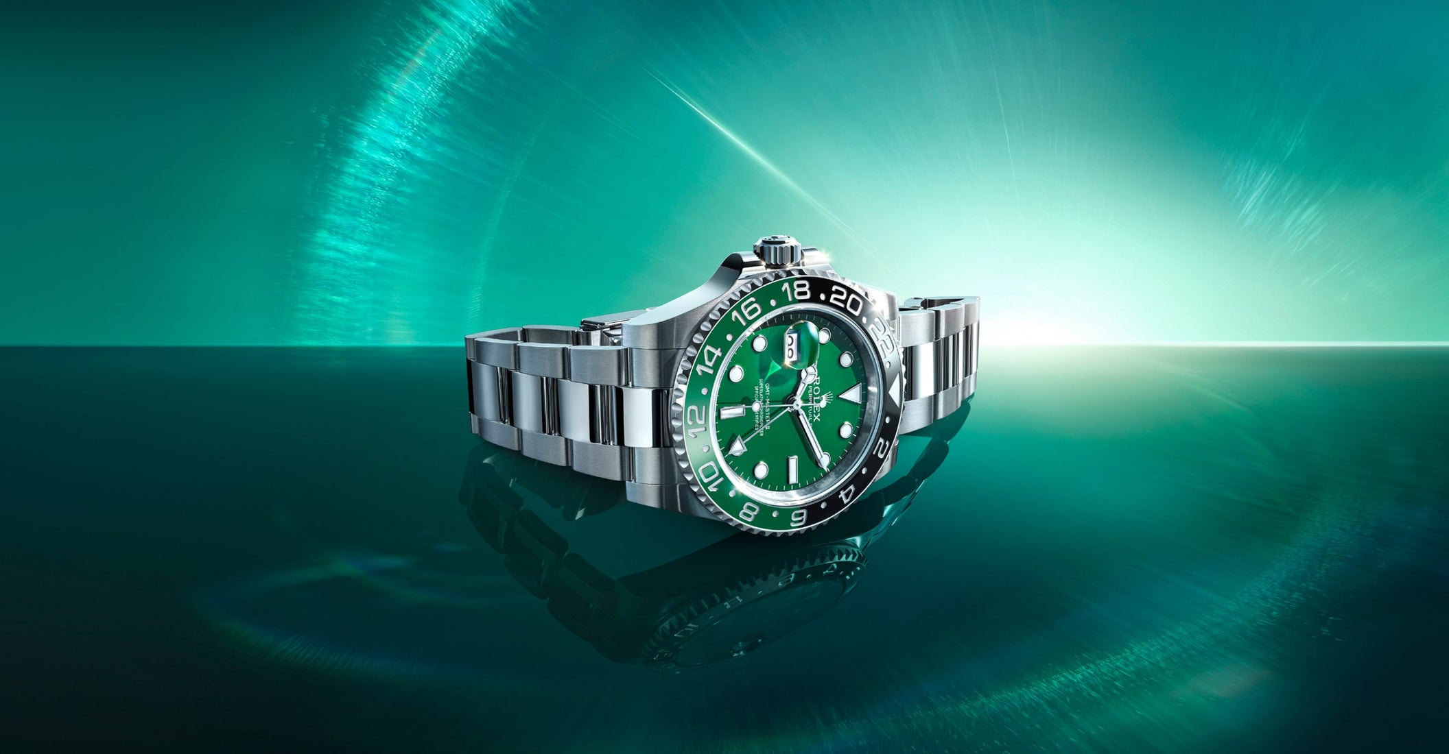 Rolex GMT-Master II watch with green dial and black-green ceramic bezel, stainless steel bracelet underwater with light rays filtering through