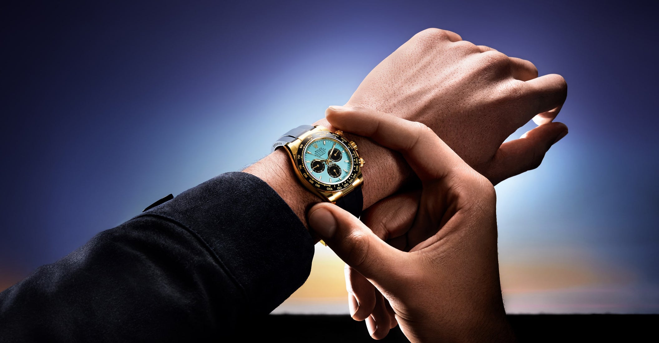 Man securing Rolex Cosmograph Daytona watch m126518ln-0014 on left wrist with right hand