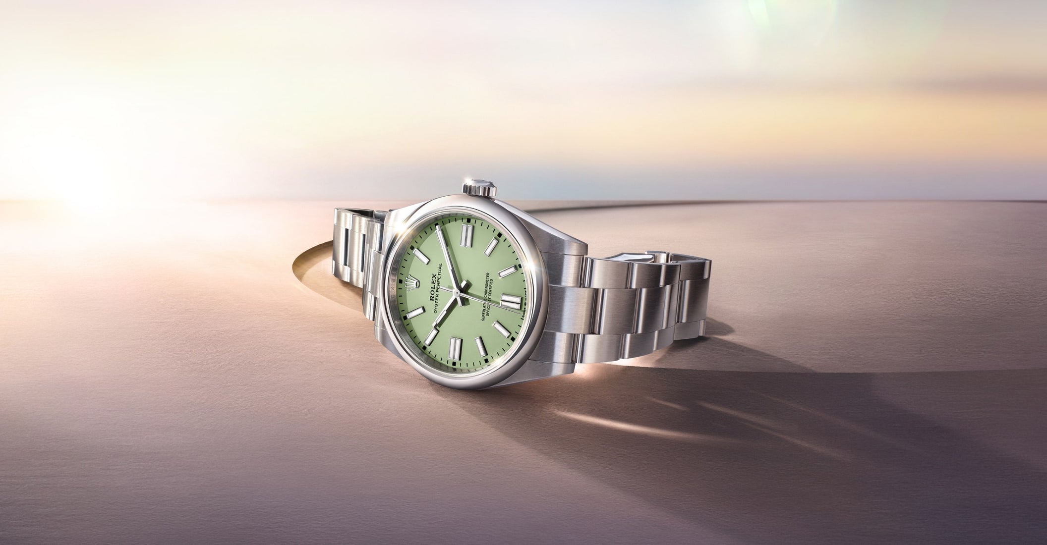 Rolex Oyster Perpetual 2025 model M134300-0006 shown in an ambient setting, highlighting the watch's detailed dial, sleek case, and polished bracelet with soft lighting that emphasizes its refined elegance.