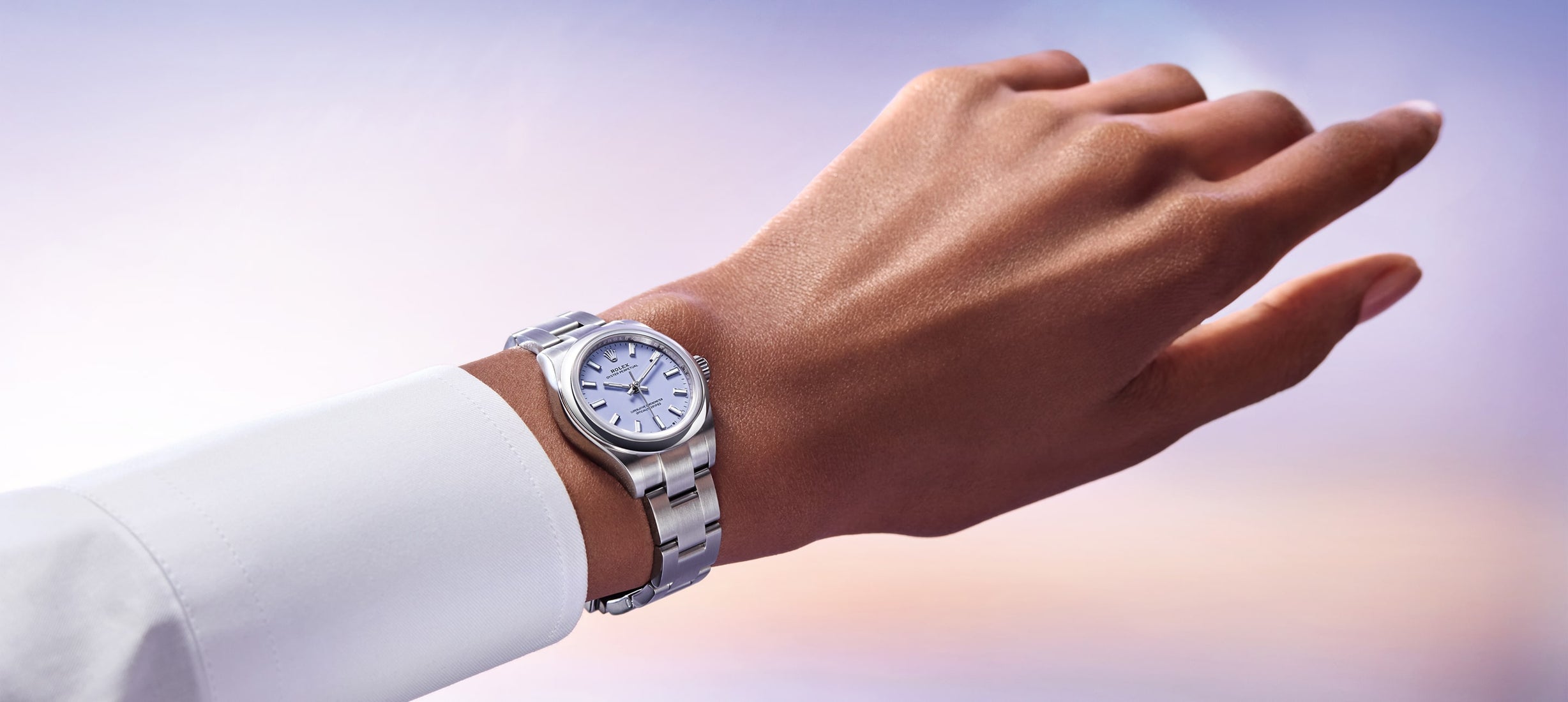 Rolex Oyster Perpetual watch model M276200-0008 presented in an elegant ambiance for 2025, showcasing a refined design with a contemporary dial and polished finish on a subtle, blurred background.