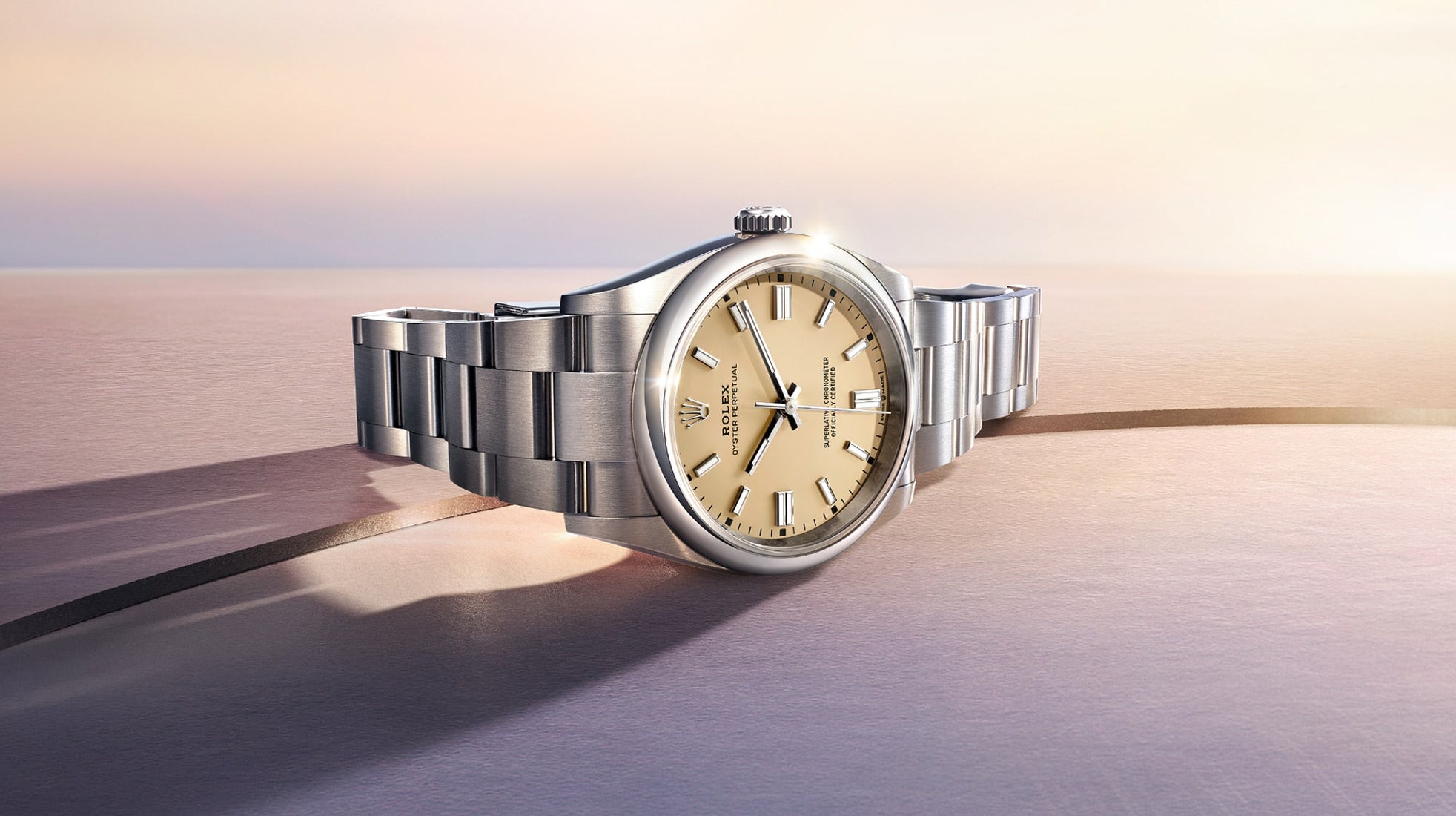 Rolex Oyster Perpetual watch model M126000-0012 featuring the essence of the Oyster design for 2025, displayed with a clear and elegant presentation on a light background.