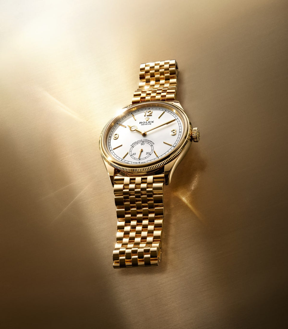 2025 Rolex Perpetual 1908 18K Yellow Gold White dial watch m52508-0008 laid on brushed golden metal table