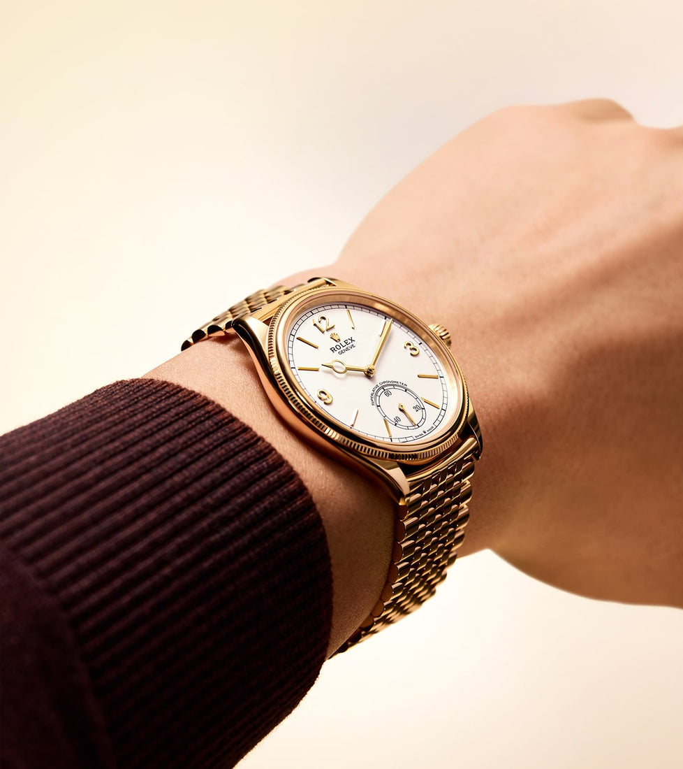 Rolex Perpetual 1908 model M52508-0008 shown worn on wrist, highlighting its elegant round bezel, classic dial with bold markers, and refined bracelet, captured in a lifestyle setting with soft natural lighting.