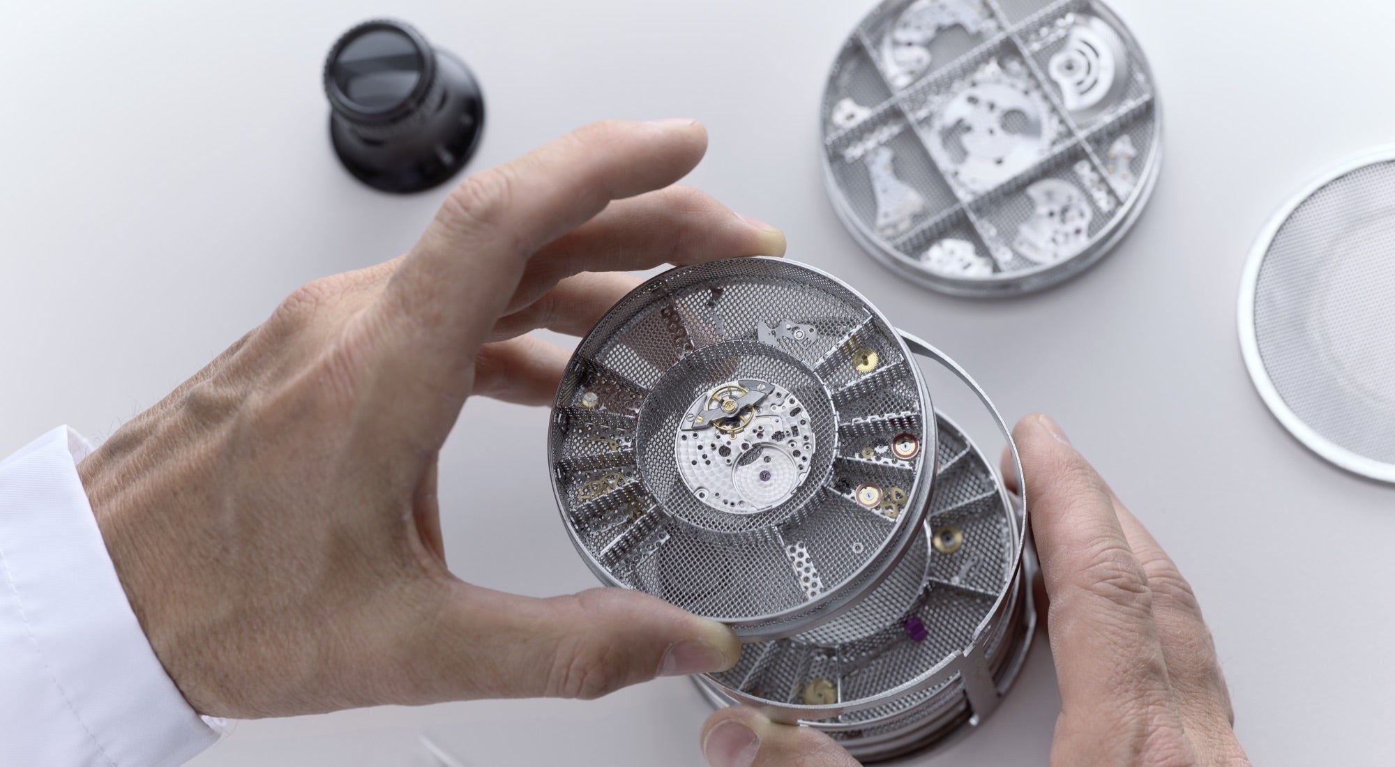 Cleaning of the watch movement using a specialized ultrasonic cleaning machine to remove dust, oils, and impurities, ensuring optimal performance and longevity during the servicing process.