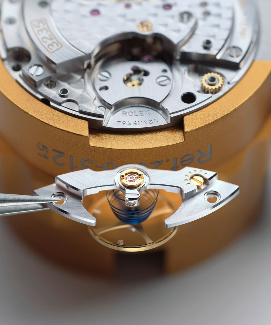 Assembly of the watch movement with the placement of the oscillator, highlighting the crucial step where the balance wheel and hairspring are installed to regulate the watch’s timing accuracy during servicing.