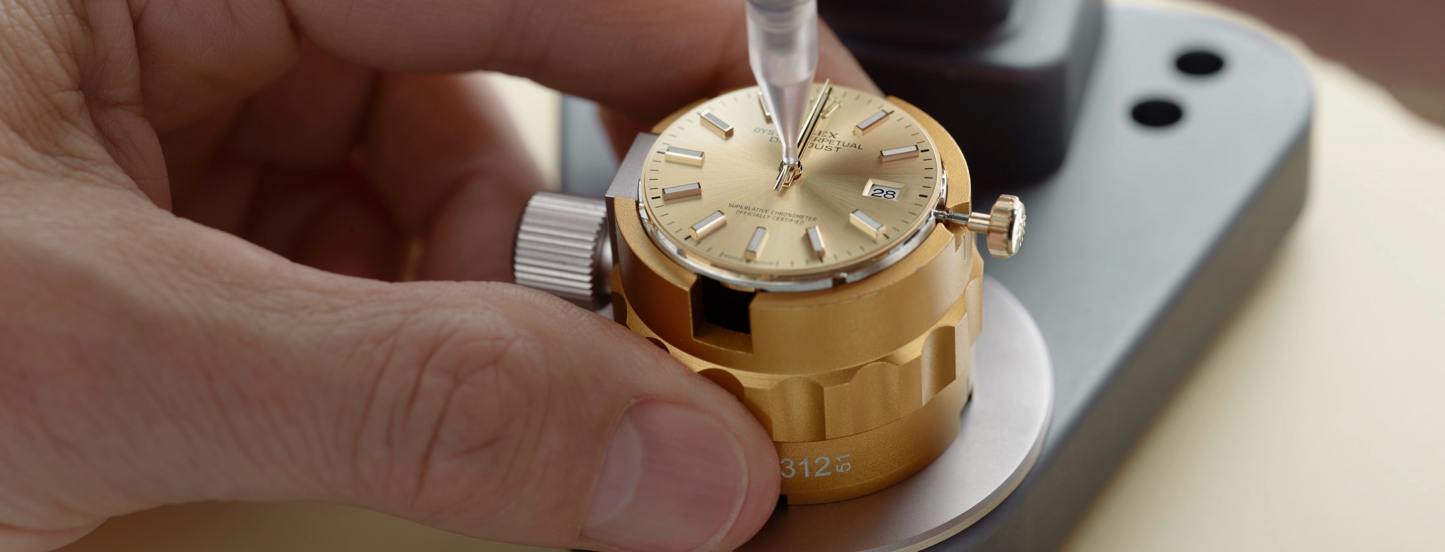 The detailed watchmaking process in Rolex's servicing procedure features an expert technician carefully assembling or adjusting the watch hands (chasing the hands). This step highlights the precision and skill involved in maintaining the watch's accuracy and craftsmanship.